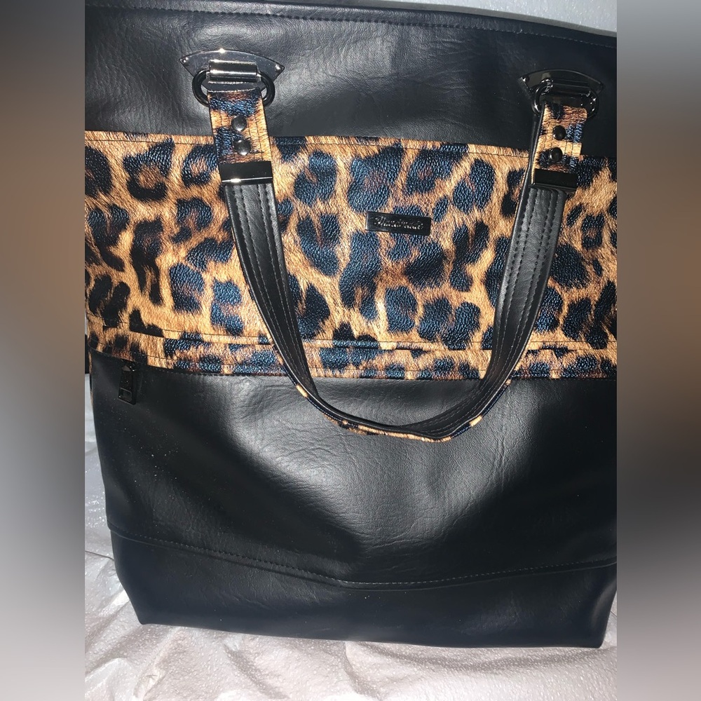 The brand is handmade it’s a black leopard print purse
